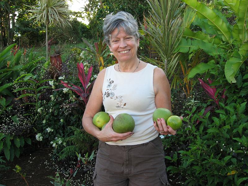 IMG_0746 Ruth holds our first grapefruit harvest (3 of them) and a passion fruit (the small one).