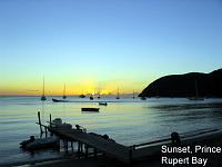 bay-sunset-1 Prince Rupert Bay: Ruth and I, along with our dear friend Nathalie, went to dinner to celebrate our thirty-first wedding anniversary at the Blue Bay restaurant just outside of Portsmouth, in the village of Lagon, and right on Prince Rupert Bay. At our dinner we enjoyed the sunset over the bay and the lights of Portsmouth. The large landform on the right side of the sunset photos is the Cabrits, where Fort Shirley overlooks the bay.