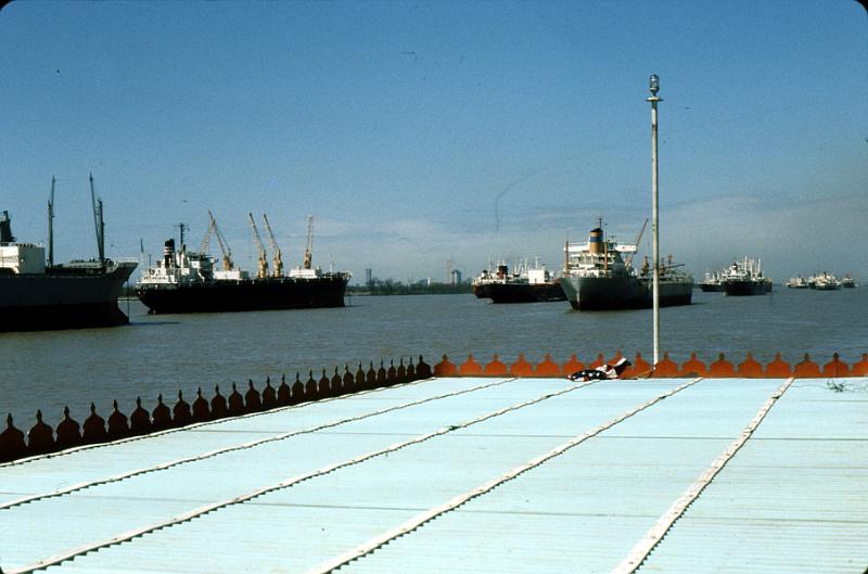 river-15 Over our ship's shade awning.  Ships are lined up for loading/off-loading in this busy port.
