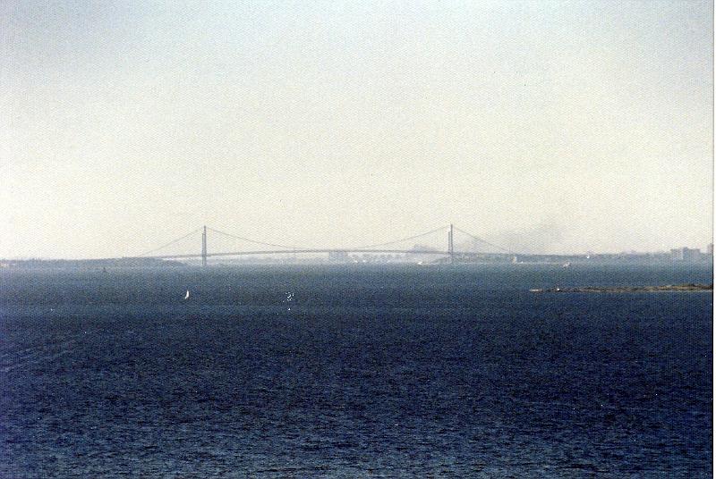 04 When it opened in 1964, the Verrazano-Narrows Bridge was the world's longest suspension span. The ends of the bridge are at historic Fort Hamilton in Brooklyn and Fort Wadsworth in Staten Island, both of which guarded New York Harbor at the Narrows for over a century. The bridge was named after Giovanni da Verrazano, who, in 1524, was the first European explorer to sail into New York Harbor. Its monumental 693 foot high towers are 1 5/8 inches farther apart at their tops than at their bases because the 4,260 foot distance between them made it necessary to compensate for the earth's curvature. Each tower weighs 27,000 tons and is held together with three million rivets and one million bolts. Seasonal contractions and expansions of the steel cables cause the double-decked roadway to be 12 feet lower in the summer than in the winter. (Source: NY Metropolitan Transit Authority)