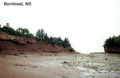 burntcoat-8 To grasp the scale in this photo: The dot near the bottom of the cliff at the center is a man. The Queen Elizabeth II, which draws 35 feet of water could steam between the cliff and the 