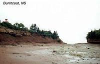 burntcoat-8 To grasp the scale in this photo: The dot near the bottom of the cliff at the center is a man. The Queen Elizabeth II, which draws 35 feet of water could steam between the cliff and the 