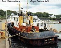 hawkesbury-1 Port Hawkesbury, Cape Breton, Nova Scotia: Port Hawkesbury is the first town on the Cape Breton end of the causeway across the Canso Strait connecting Nova Scotia's main island with its peninsula. We stopped here so that Ruth could check out the cooperative collective quilt market. I, meanwhile, waited on the pier, where I photographed some boats and where I met some local folk who, probably in order to get me to quit playing my harmonica, permitted me to fish for mackerel with their rods. I caught several.