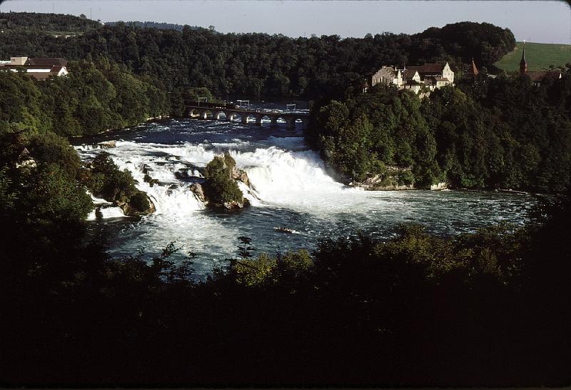 Rheinfall_with_Castle_Laufen The Tanner family came from Schaffhausen but now lives in Neuhausen.  Neuhausen am Rheinfall (which was officially called Neuhausen until 1938) is a municipality in the canton of Schaffhausen in Switzerland. The little town is well known for the Rhine Falls, a tourist attraction and mainland Europe's largest waterfall. The remaining Tanner family lives not far from here and can see the Rheinfall from a top-floor window.  The castle is a youth hostel.  The train is running on electricity provided by water turbines that are hidden in tunnels.