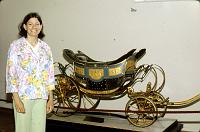 NapoleanII_baby_coach To show scale, Ruth is standing next to the Children's Phaeton of the King of Rome, son of Emperor Napoleon and Empress Marie-Louise in 1811-12.  It was built by Tremblay in Paris.  The gold dots on the black body are bees, the Napoleonic emplem.